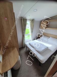 a bedroom with a bed with rings on it at Flamingo Land - Cedar Wood CW49 in Kirby Misperton