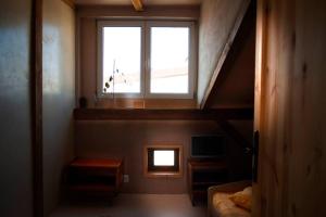 a room with a staircase with a window and a bed at Caly apartament in Bydgoszcz