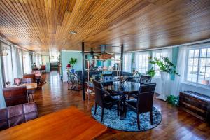 a living room with a wooden ceiling and a table at The Newport Belle in Newport