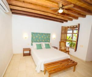 a bedroom with a bed and a ceiling fan at Bioma Boutique Hotel in Mompos