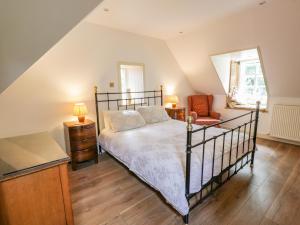ニュートン・スチュワートにあるThe Coach Houseのベッドと椅子のある寝室