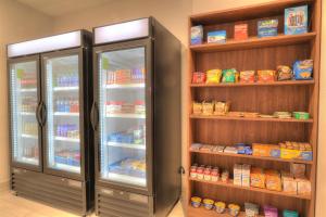 a refrigerator filled with lots of different types of food at Holiday Inn Express Hotel & Suites Mobile Saraland, an IHG Hotel in Saraland