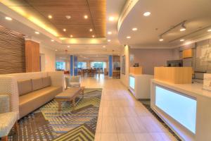 a lobby of a hospital with a couch and a table at Holiday Inn Express Hotel & Suites Mobile Saraland by IHG in Saraland