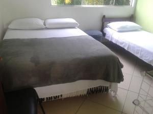 Postel nebo postele na pokoji v ubytování Pousada Encantadas