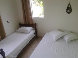 Postel nebo postele na pokoji v ubytování Pousada Encantadas