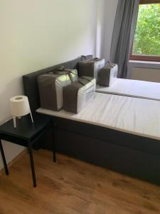 a bedroom with a bed with three pillows on it at Ferienwohnung Obernkirchen in Obernkirchen +3 photos