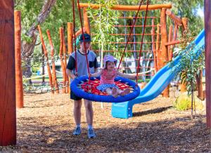 a boy and a girl are playing in a park at BIG4 Emu Beach Holiday Park in Albany