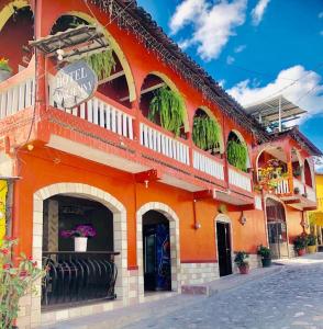 an orange building with plants on the side of it at Hotel Marjenny in Copan Ruinas