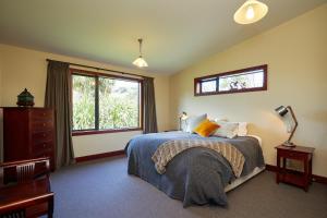 a bedroom with a bed and a window at Glencree Luxury Chalets in Kaikoura