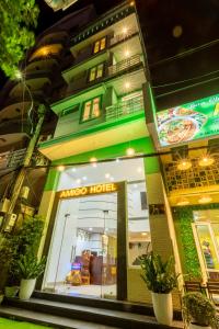 a store front of a building with a sign on it at Amigo Hue Hotel in Hue