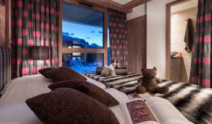 a bedroom with a teddy bear sitting on a bed at CGH Résidence Boutique Le Centaure in Flaine +23 photos