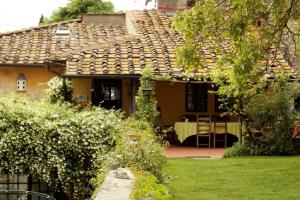 una casa con mesa y sillas en un patio en Le Tre Colombe, en Bagno a Ripoli