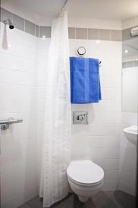 a bathroom with a toilet and a blue towel at David Russell Apartments - Campus Accommodation in St Andrews