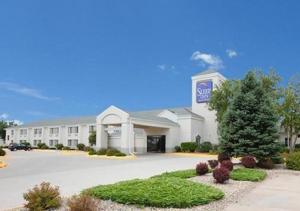 a large white building with a sign on it at Sleep Inn & Suites Columbus in Columbus