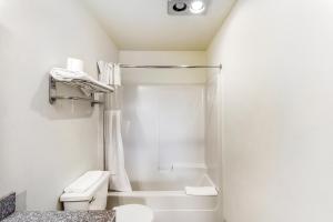 ein weißes Badezimmer mit Dusche und Toilette in der Unterkunft Arlington Motor Inn in Arlington + 37 Fotos