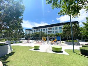 a park with a playground in front of a building at Homesuite' Home at The Loft in Kota Kinabalu