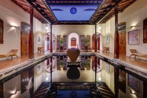 a swimming pool with a vase in the middle at Apa Villa Illuketia in Unawatuna