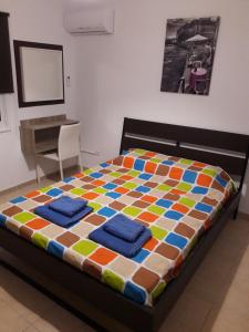 a bedroom with a colorful bed with towels on it at Holiday home in Larnaca