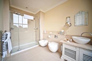a bathroom with a shower and a toilet and a sink at Champneys Tring in Tring