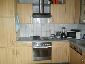 Una cocina con gabinetes de madera y un horno de estufa. en Bamerhof, en Mittersill 11 fotos más