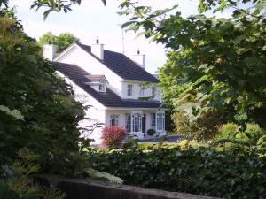 a white house with a black roof at Lake Avenue House in Ballyconnell