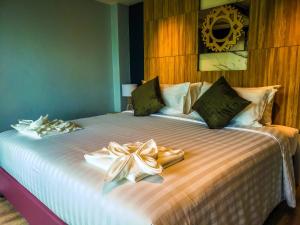 a bedroom with a bed with two towels on it at Niramaya Villa & Wellness in Ko Yao Noi