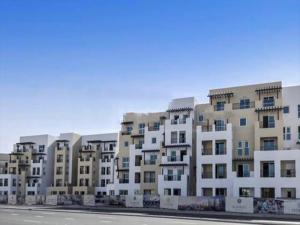 a row of apartment buildings sitting next to a street at OYO 597 Home al khail heights 335, G19 in Dubai