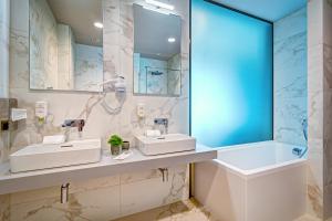 a bathroom with two sinks and a large mirror at Old Town Haston in Wrocław