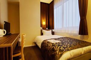 Postel nebo postele na pokoji v ubytování Tachikawa Regent Hotel