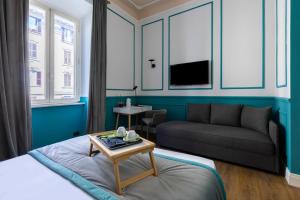 a living room with a bed and a couch at Hotel Coppede' in Rome