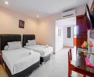 Postel nebo postele na pokoji v ubytování Dna Fun Zone Pekanbaru + 37 fotografií