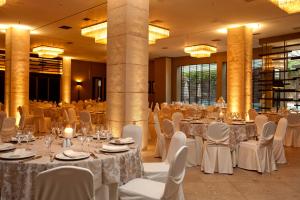 a banquet hall with white tables and chairs at Congo Palace in Athens +37 photos