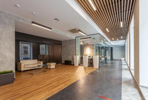 an office lobby with a couch and a table at Hotel Kronverk in Saint Petersburg