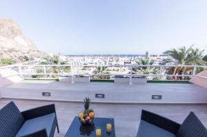 a balcony with a table and chairs and a view of the beach at Seaport Aguadulce Beach in Aguadulce