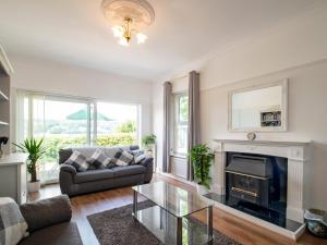 a living room with a couch and a fireplace at Bryn Y Mor in Colwyn Bay