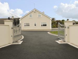 a driveway with gates in front of a house at Loughanure Lake View in Annagry