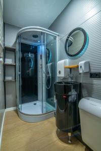 a bathroom with a shower and a sink at Landscapes Hotel Kazbegi in Stepantsminda