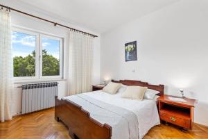 a bedroom with a bed and a window at Holiday house with swimming pool in Viskovo +52 photos