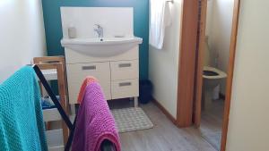 a bathroom with a sink and a toilet and towels at Champion Road Studio in Stoke