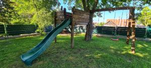 a playground with a slide in the grass at Dom Dziadka in Janów Podlaski