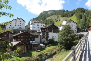 a village in the mountains with a bridge at Apartment Beeli in Splügen