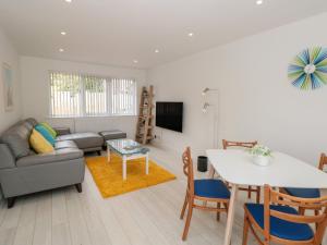 a living room with a couch and a table at Little Starboard in Kingsbridge