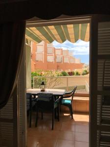 a table and chairs on a balcony with a view of a building at INN Orlando in Adeje