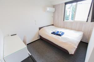 Postel nebo postele na pokoji v ubytování Port House Hatsudai + 24 fotografií