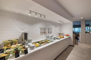 a buffet line with many different types of food at Holiday Inn Swindon, an IHG Hotel in Swindon
