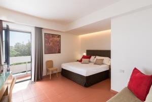 a bedroom with a bed and a large window at Rada Siri in Montepaone