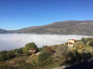 Casas del CastañarにあるMi Valle Ruralの雲の丘の上の家