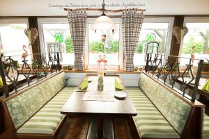 a dining room with a table and some windows at Landhotel Napoleon in Wipperfürth