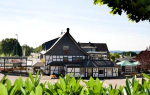 a large white building with a black roof at Landhotel Napoleon in Wipperfürth