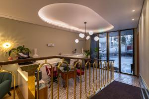 a dining room with a table and chairs on a balcony at The Convo Porto Hotel & Suites in Porto